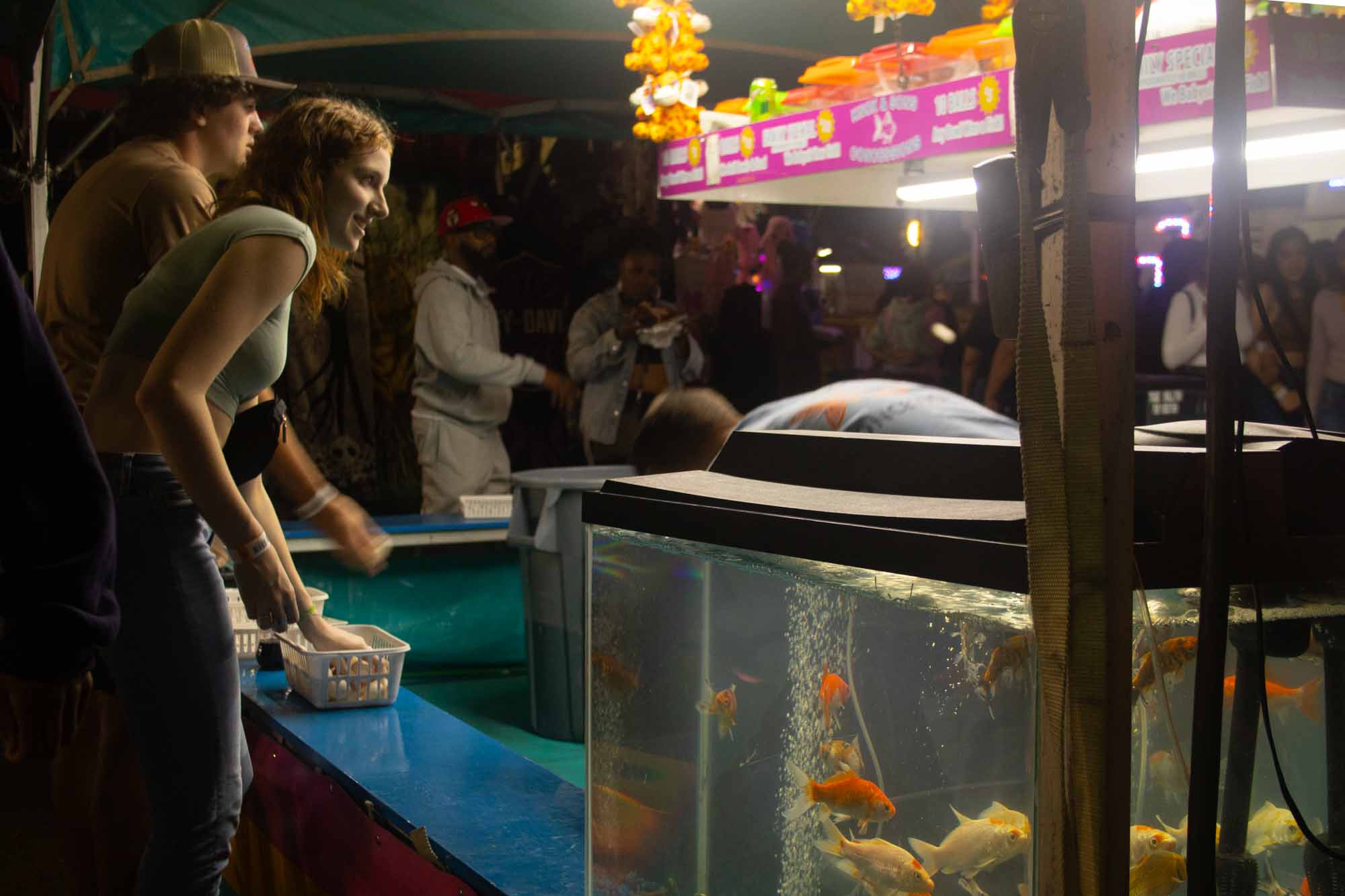The Carolina Classic Fair attracts visitors from all over the state to eat fried foods and play carnival games. The couple photographed attempts to win a gold fish at the ring toss tent. The goal for the photoshoot was to capture a photo with great light and a portrait of someone, who experienced a life changing event.
